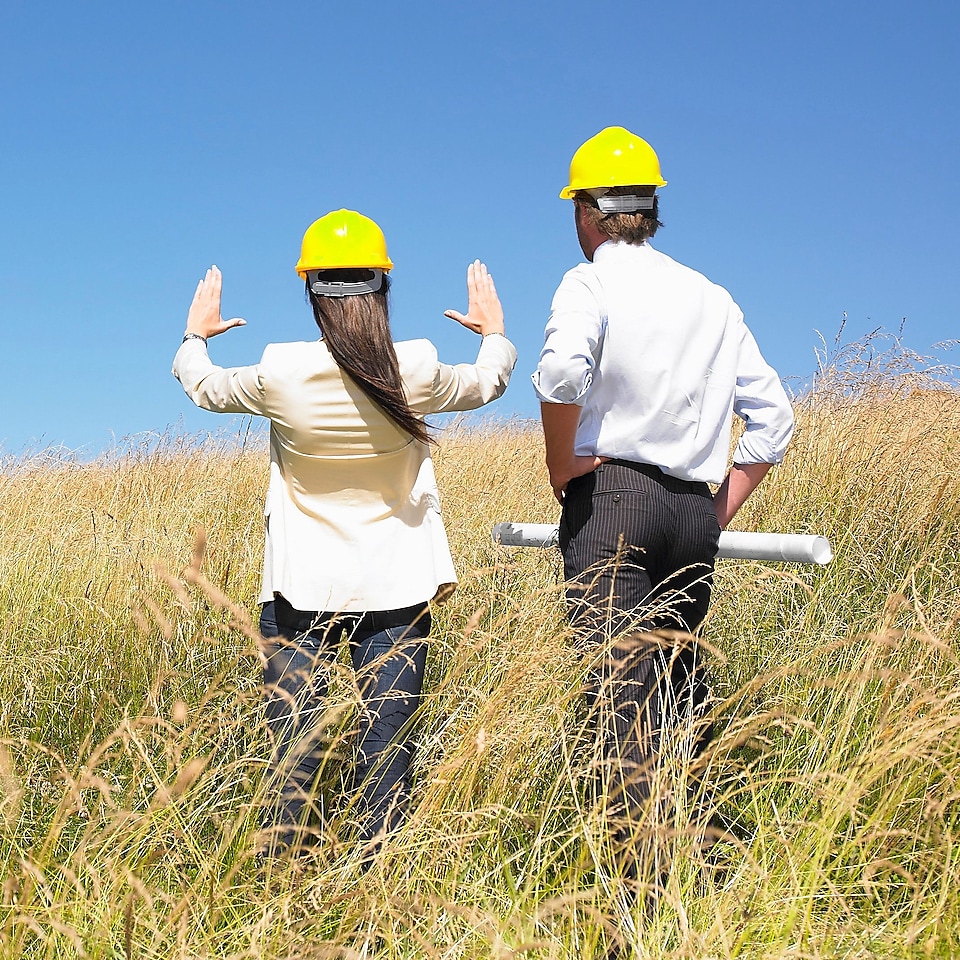 man and a woman discussing a future construction site