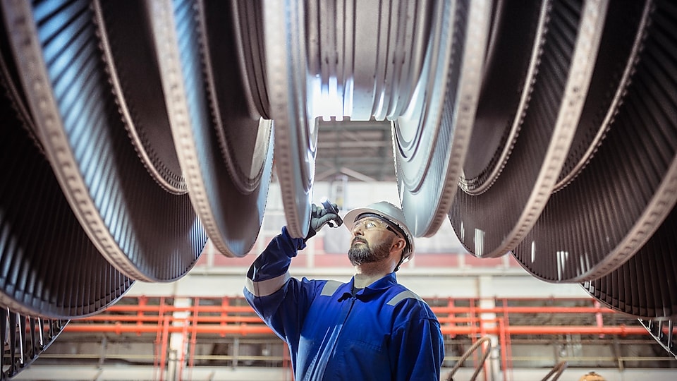 Engineer inspecting a turbine in a nuclear power station